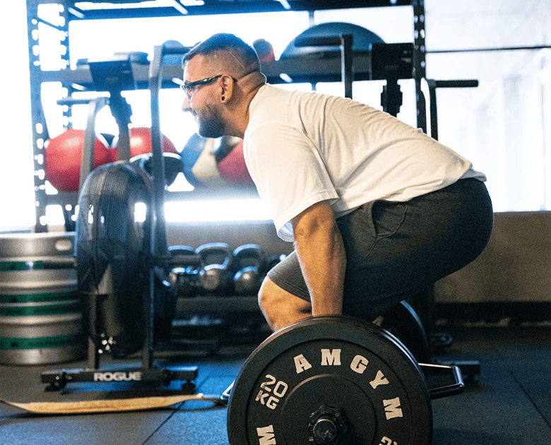 man lifting weights at Spartan Nation Combatives and Fitness